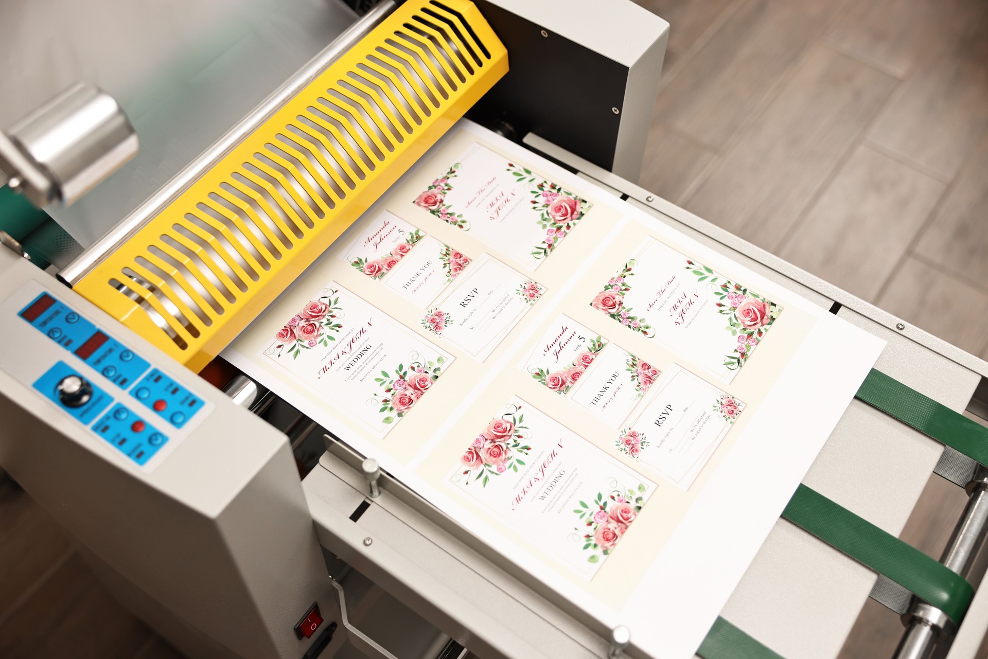 Modern roll laminator and paper sheet with invitation cards indoors, closeup. Printing house